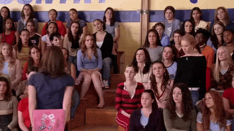 A GIF from Mean Girls of a group of people raising their hands