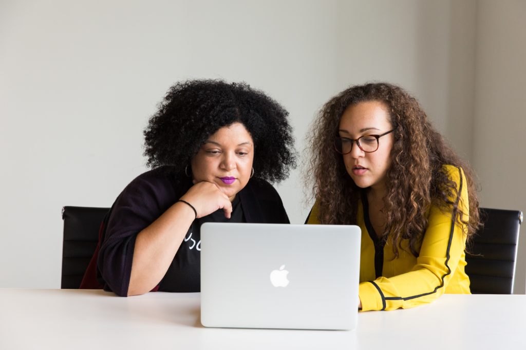 Photo of two female colleagues working on a laptop together