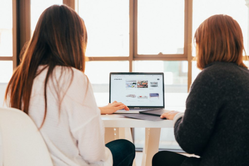 Photo of two female colleagues working on a laptop together