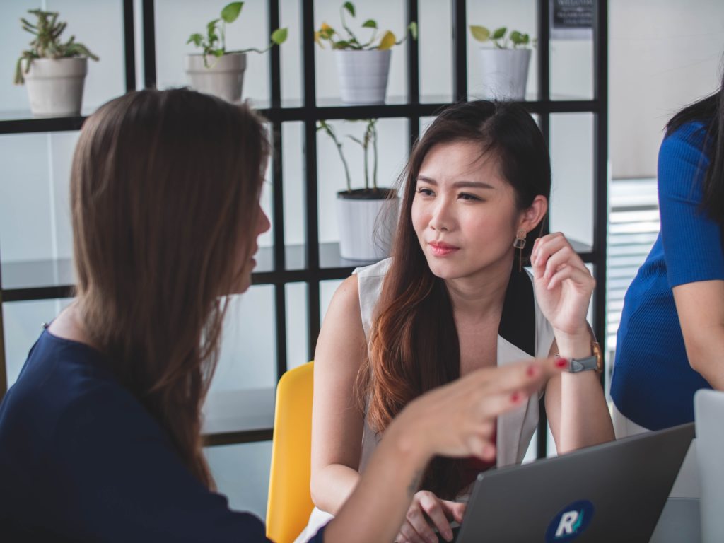 Photo of two female colleagues discussing work